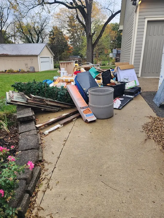 Dumpster being loaded with debris for 12 Yard Dumpster Rental in Deerfield